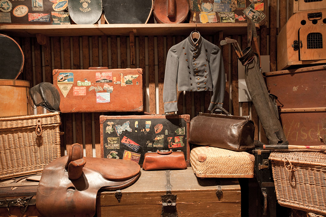 A detail shot of an exhibit at the Belle Epoque museum at the resort. There are many knickknacks on display such as a a horse saddle, travel trunks, golf clubs and a blazer for a uniform.