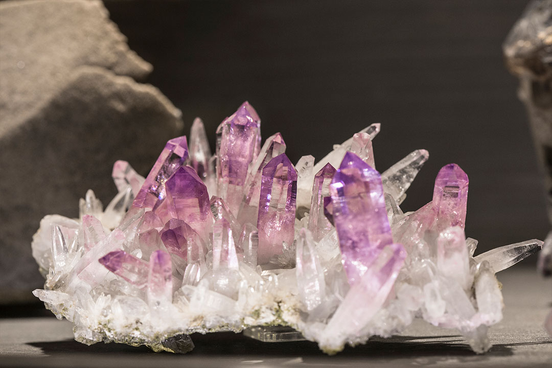 a detail shot of a jagged crystal formation on display at the Belle Epoque museum at the resort. The crystal is clear white at the bottom and gradually becomes purple at the top of each crystal formation.