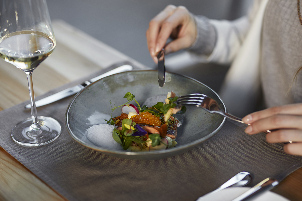 Enjoying a delicious dish from our Brasserie at Waldhaus Flims Wellness Resort